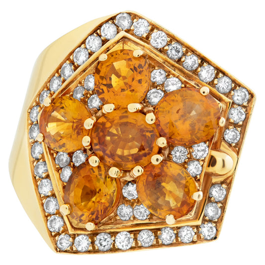 Oval brilliant cut orange sapphire & diamond ring set in 18K gold. Orange sapphires approx total weight over 7.00 carats. Round brilliant cut diamonds approx total weight: 1.00 carat