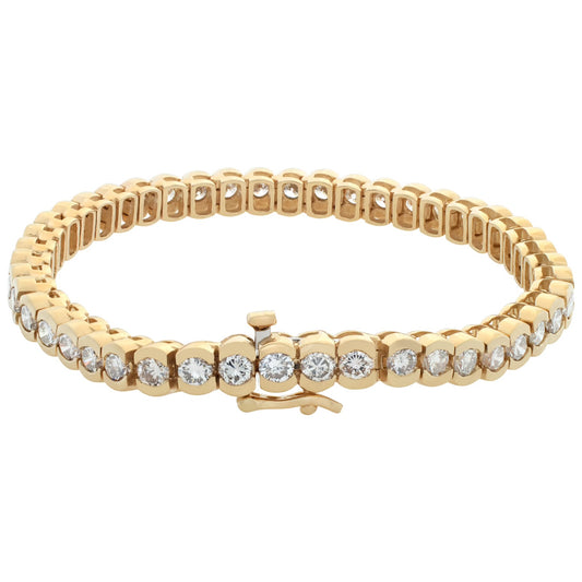 Diamond tennis bracelet in 14k yellow gold with over 7 carats in round diamonds